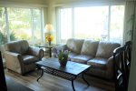 Large living room windows provide a lot of natural light